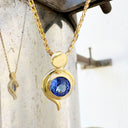 Tanzanite Pendant With Yellow Gold Bead and Curve Detail
