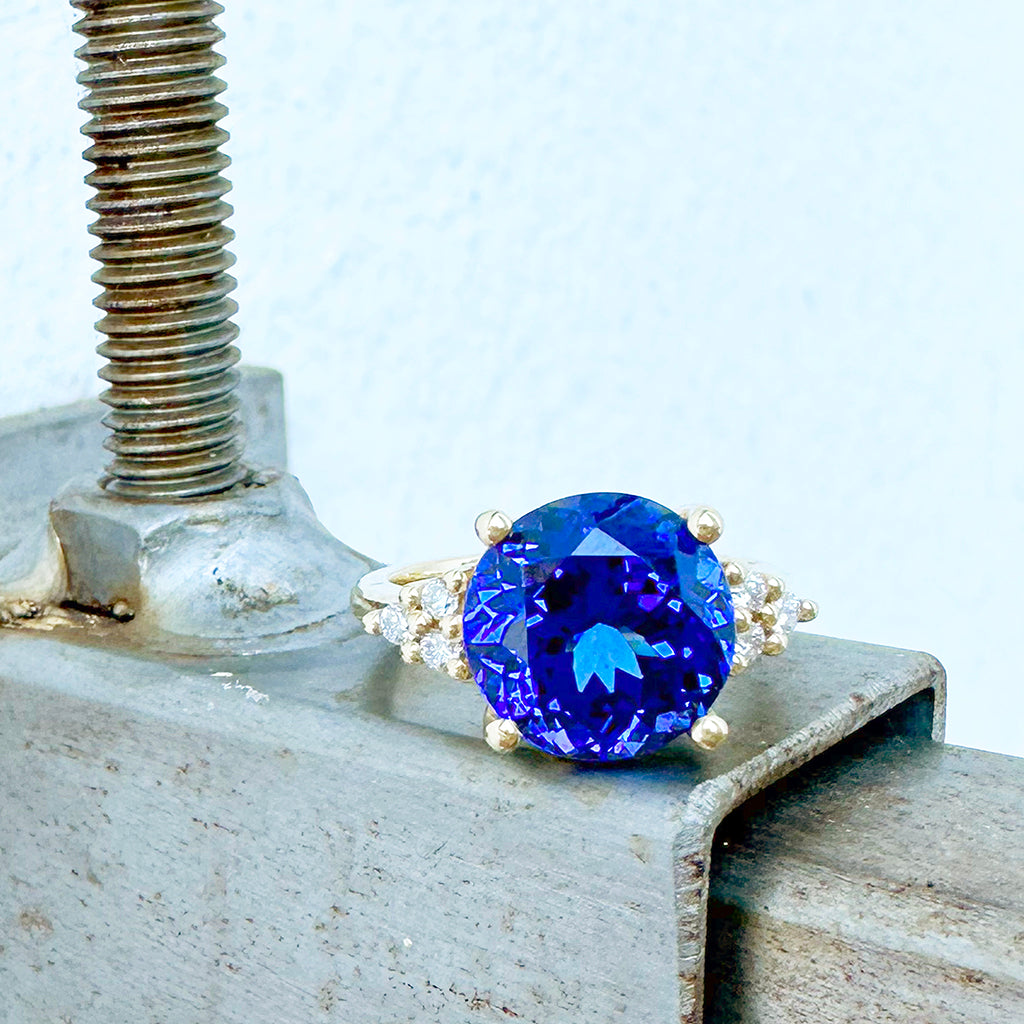 Visionary Round Cut Tanzanite With Trilogy Shoulder Highlight Yellow Gold Ring