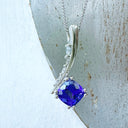 Ultra Glam Cushion Cut Tanzanite and Elaborate Side Sweep White Diamond Bale Pendant