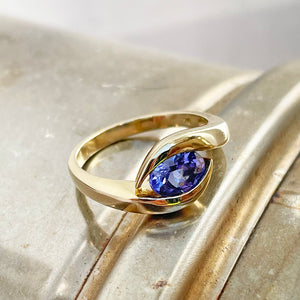 Gently Embraced Oval Tanzanite Yellow Gold Ring