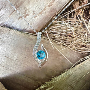 Curvaceous Blue Topaz and Diamond Pendant