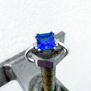 Elevated Double Claw Cushion Cut Tanzanite and Diamond Highlight White Gold Ring