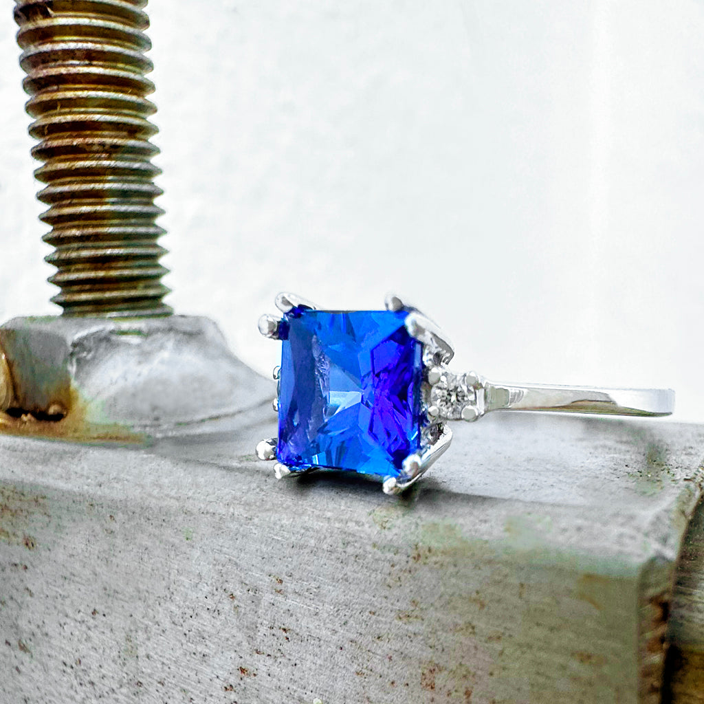 Elevated Double Claw Cushion Cut Tanzanite and Diamond Highlight White Gold Ring