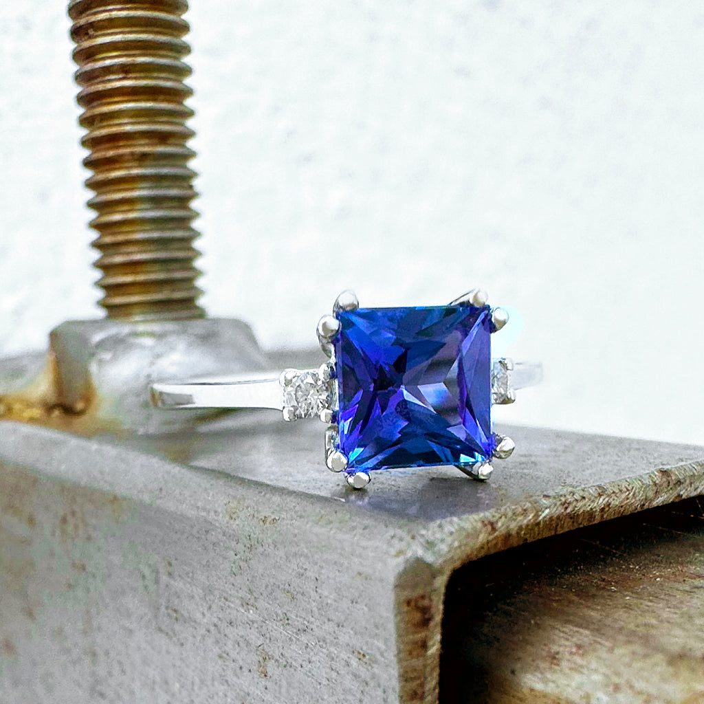 Elevated Double Claw Cushion Cut Tanzanite and Diamond Highlight White Gold Ring