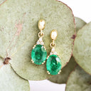 Elegant Oval Cut Emerald and Trilogy Diamond Drop Earrings In Yellow Gold
