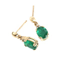 Elegant Oval Cut Emerald and Trilogy Diamond Drop Earrings In Yellow Gold