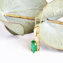 Elegant Oval Cut Emerald and Trilogy Diamond Pendant In Yellow Gold