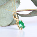 Elegant Oval Cut Emerald and Trilogy Diamond Pendant In Yellow Gold