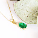 Elegant Oval Cut Emerald and Trilogy Diamond Pendant In Yellow Gold