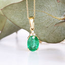 Elegant Oval Cut Emerald and Trilogy Diamond Pendant In Yellow Gold
