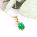 Elegant Oval Cut Emerald and Trilogy Diamond Pendant In Yellow Gold