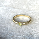 Elegant Round Cut Peridot Yellow Gold Ring with a Twist