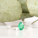 Elevated Four Claw Emerald Ring With Diamond Shoulders In White Gold