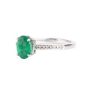 Elevated Four Claw Emerald Ring With Diamond Shoulders In White Gold