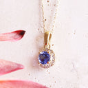 Elevated Tanzanite and Diamond Halo Pendant in Yellow Gold