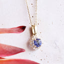 Elevated Tanzanite and Diamond Halo Pendant in Yellow Gold