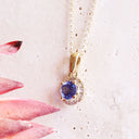 Elevated Tanzanite and Diamond Halo Pendant in Yellow Gold