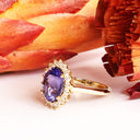 Enchanting Oval Shaped Diamond Halo and Tanzanite Yellow Gold Ring