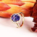 Enchanting Oval Shaped Diamond Halo and Tanzanite Yellow Gold Ring