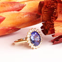 Enchanting Oval Shaped Diamond Halo and Tanzanite Yellow Gold Ring