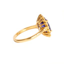 Enchanting Oval Shaped Diamond Halo and Tanzanite Yellow Gold Ring