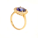 Enchanting Oval Shaped Diamond Halo and Tanzanite Yellow Gold Ring