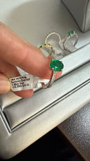Elevated Four Claw Emerald Ring With Diamond Shoulders In White Gold