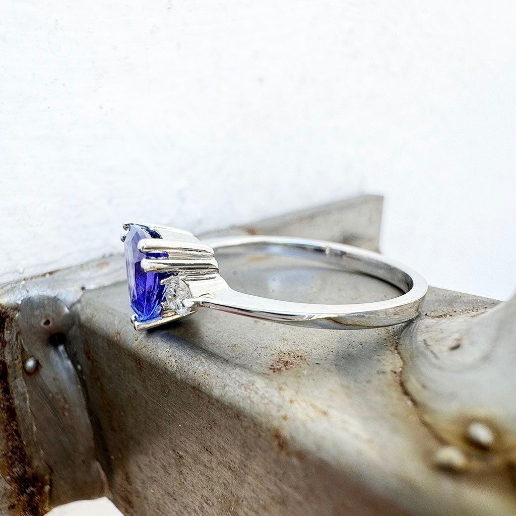 White Gold Double Claw Trilliant Cut Tanzanite With Diamond Shoulder Highlight Ring