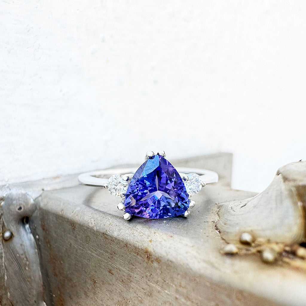 White Gold Double Claw Trilliant Cut Tanzanite With Diamond Shoulder Highlight Ring