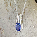 Split White Gold Oval Tanzanite Pendant with Diamond Stripe Highlight