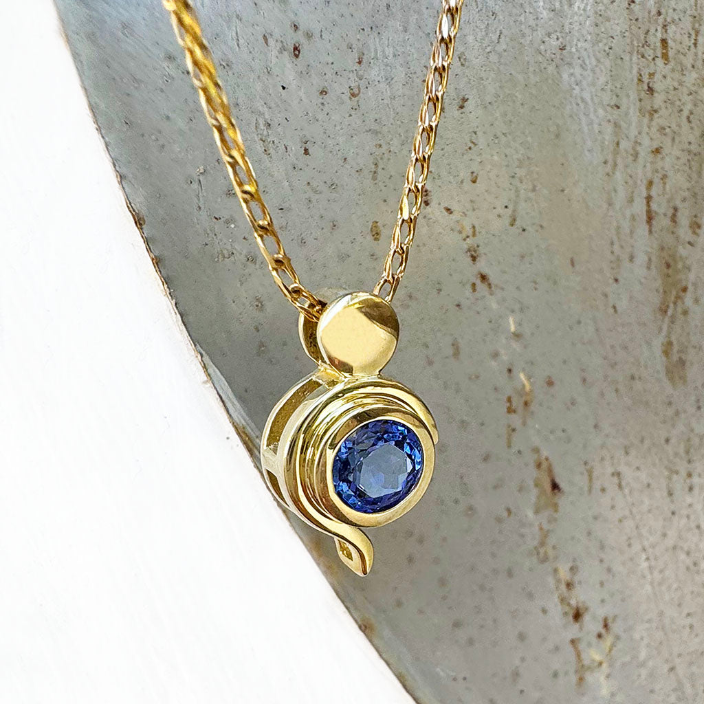 Tanzanite Pendant With Yellow Gold Bead and Curve Detail