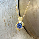 Tanzanite Pendant With Yellow Gold Bead and Curve Detail