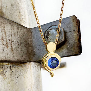 Tanzanite Pendant With Yellow Gold Bead and Curve Detail