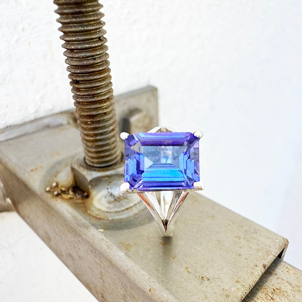 Grandly Elevated Emerald Cut Tanzanite Solitaire White Gold Ring