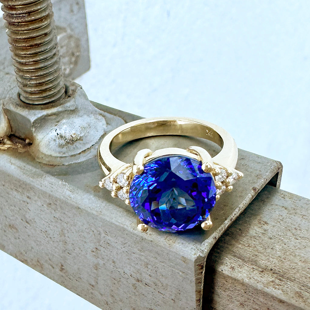 Visionary Round Cut Tanzanite With Trilogy Shoulder Highlight Yellow Gold Ring