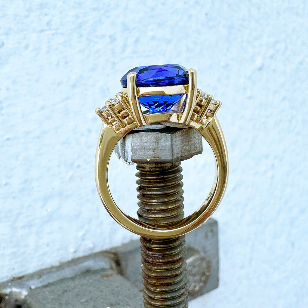 Visionary Round Cut Tanzanite With Trilogy Shoulder Highlight Yellow Gold Ring