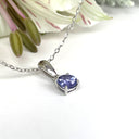Silver Petite Round Cut Tanzanite with Single Diamond Pendant