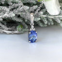 Silver Oval Cut Tanzanite with Trilogy Silver Topaz Highlight Pendant