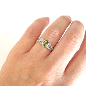 Ornate Oval Cut Peridot Ring with Diamond Step Detail