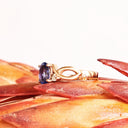 Oval Tanzanite Ring With Diamond Half Infinity Twist Shoulders in Rose Gold