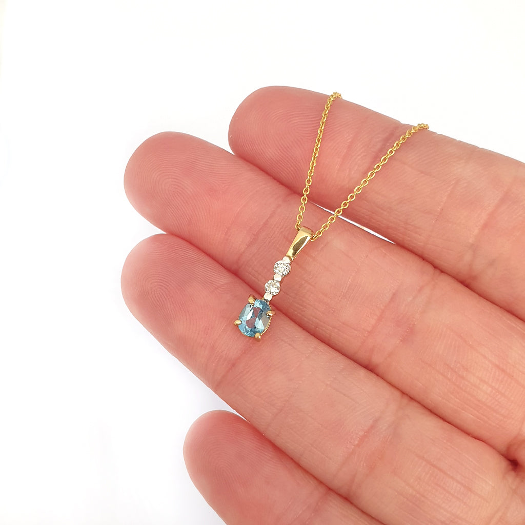 Petite Oval Cut Blue Topaz and Diamond Pendant