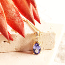 Petite Oval Tanzanite Yellow Gold Pendant with White Diamond Bale Highlight