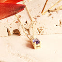 Petite Oval Tanzanite Yellow Gold Pendant with White Diamond Bale Highlight