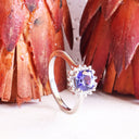 Poised Cushion Cut Tanzanite And Diamond Halo White Gold Ring