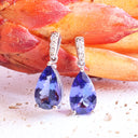 Prestigious Pear Cut Tanzanite And Delightful Diamond Highlight White Gold Earrings