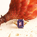 Regal Elevated Emerald Cut Tanzanite Solitaire Yellow Gold Ring