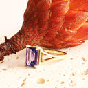 Regal Elevated Emerald Cut Tanzanite Solitaire Yellow Gold Ring