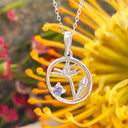Silver Circular Silver Bird of paradise tanzanite pendant