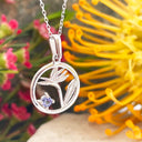 Silver Circular Silver Bird of paradise tanzanite pendant
