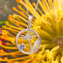 Silver Circular Silver Bird of paradise tanzanite pendant